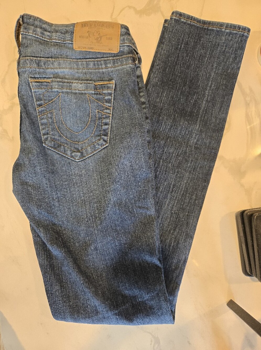 True Religion Skinny Jeans in Mid Blue with Tan Patch. Size 27